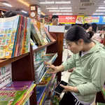 Phụ huynh tìm mua sách tại nhà sách ADCbook tối 7/9, nhưng trên các kệ hầu như chỉ còn sách tham khảo. (Ảnh: Phạm Mai/Vietnam+)
