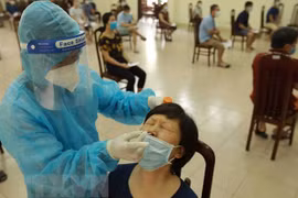 Nhân viên y tế lấy mẫu xét nghiệm cho người dân ở phường Trung Hoà (Cầu Giấy). (Ảnh: Vũ Sinh/TTXVN) 