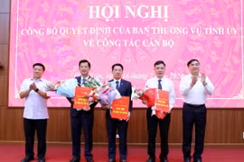 Bí thư Tỉnh ủy Điện Biên Trần Quốc Cường (phải) và Chủ tịch Hội đồng Nhân dân tỉnh Điện Biên Lò Văn Phương trao Quyết định và hoa chúc mừng các đồng chí được bổ nhiệm vị trí công tác mới. (Ảnh: Trung Kiên/TTXVN)