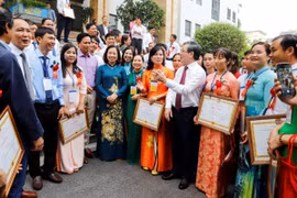 Chủ tịch Trung ương Hội Nông dân Việt Nam Lương Quốc Đoàn nói chuyện với các nông dân Việt Nam xuất sắc. (Ảnh: TTXVN phát)