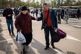 Người dân Ukraine sơ tán từ thành phố Mariupol tới thành phố Zaporizhzhia. (Ảnh: AFP/TTXVN)