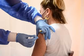 Nhân viên y tế tiêm vaccine phòng COVID-19 cho người dân. (Ảnh: AFP/TTXVN) 