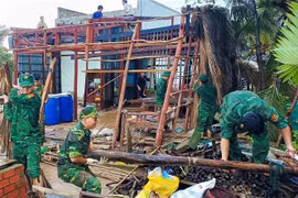Bộ đội Biên phòng Cà Mau giúp người dân xã Khánh Hội, huyện U Minh dựng lại nhà bị sập do ảnh hưởng cơn bão số 1. (Ảnh: TTXVN phát)