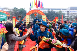 Các tân binh bước qua cổng vinh quang trong sự chào đón của hàng trăm bạn bè, gia đình, người thân. (Ảnh: Minh Sơn/Vietnam+) 