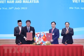 Thủ tướng Phạm Minh Chính và Thủ tướng Anwar Ibrahim chứng kiến lễ ký Bản ghi nhớ về hợp tác giữa Liên đoàn Thương mại và Công nghiệp Việt Nam với Phòng Thương mại và Công nghiệp Quốc gia Malaysia ngày 20/7/2023. (Ảnh: Dương Giang/TTXVN) 