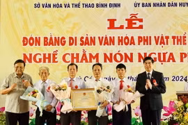 Trao Bằng chứng nhận di sản văn hóa phi vật thể Quốc gia "Nghề chằm nón ngựa Phú Gia" cho Đảng bộ, chính quyền huyện Phù Cát. (Ảnh: TTXVN phát)