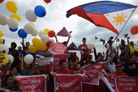 Các nhà hoạt động Philippines vui mừng sau phán quyết của Tòa Trọng tài ở Lahay trong cuộc tuần hành tại Manila ngày 12/7. (Nguồn: AFP/TTXVN)