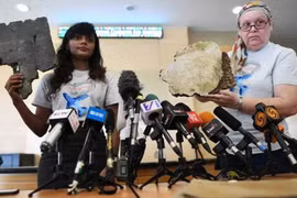 Người thân của các nạn nhân trao cho Chính phủ Malaysia những mảnh vỡ nghi của MH370. (Nguồn: AFP)