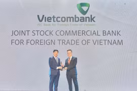 Ông Hồng Quang - Thành viên Hội đồng quản trị kiêm Giám đốc Khối Nhân sự đại diện Vietcombank nhận cúp vàng "Harmonia" từ Ban tổ chức. (Ảnh: Vietnam+)