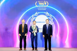 Ông Nguyễn Hướng Minh, Phó Tổng Giám đốc Eximbank (giữa) nhận Cúp giải thưởng Sản phẩm Công nghệ & Chuyển đổi số tiêu biểu năm 2024 từ Ban tổ chức. (Ảnh: Vietnam+)
