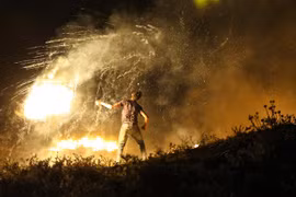Người biểu tình Palestine ném chất cháy về phía binh sĩ Israel tại khu vực biên giới Gaza và Israel, ngày 15/6/2021. (Ảnh: AFP/TTXVN)