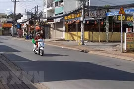 Người đi giao hàng cho các hộ dân theo khung giờ khu vực đường Đình Phong Phú, thành phố Thủ Đức, Thành phố Hồ Chí Minh. (Ảnh: Hồng Nhung/TTXVN)
