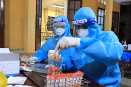 Lấy mẫu xét nghiệm SARS-CoV-2. (Ảnh: TTXVN)