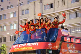 Các thành viên đội tuyển bóng đá nữ Việt Nam hào hứng trong lễ diễu hành. (Ảnh: Hồng Giang/TTXVN)