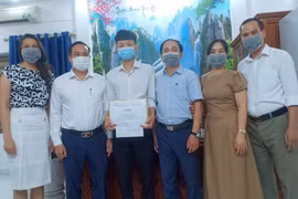 Lãnh đạo Sở Giáo dục và Đào tạo Hải Phòng chúc mừng Trần Cao Sơn đạt kết quả xuất sắc trong kỳ thi tốt nghiệp Trung học phổ thông 2021. (Ảnh: TTXVN phát)