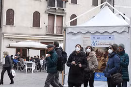 Khách du lịch đeo khẩu trang để phòng tránh lây nhiễm COVID-19 tại Venice. (Ảnh: THX/ TTXVN)