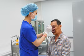 Nhân viên y tế chăm sóc cho bệnh nhân sau phẫu thuật. (Ảnh: PV/Vietnam+)