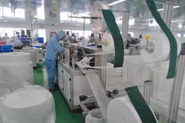 Dây chuyền sản xuất khẩu trang y tế của một công ty. (Ảnh: Minh Hưng/TTXVN)
