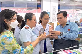 Đoàn giám sát Hội đồng Nhân dân Thành phố Hồ Chí Minh kiểm tra tại một cơ sở kinh doanh thuốc trên địa bàn quận Tân Phú. (Ảnh: Đinh Hằng/TTXVN)