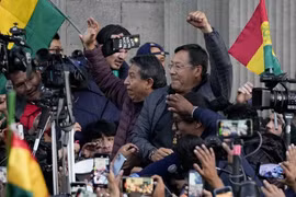 Tổng thống Bolivia Luis Arce giơ nắm đấm siết chặt giữa những người ủng hộ và giới truyền thông, bên ngoài dinh thự của chính phủ ở La Paz (Bolivia), ngày 26/6/2024. (Nguồn: AP)