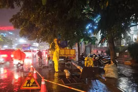 Các đơn vị ứng trực thoát nước ở khu vực đường Minh Khai, quận Hai Bà Trưng trong trận mưa lớn tối 12/5. (Ảnh: TTXVN)