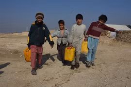 Trẻ em đi lấy nước tại trại tị nạn ở Mazar-i-Sharif, tỉnh Balkh, Afghanistan. (Ảnh: THX/TTXVN)