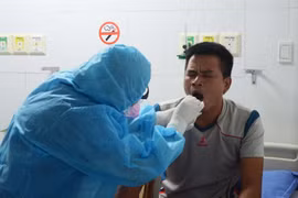 Nhân viên y tế bệnh viện 199 lấy mẫu xét nghiệm, thực hiện sàng lọc khi tiếp nhận bệnh nhân. (Ảnh: Văn Dũng/TTXVN)
