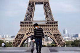 Trẻ em thăm Tháp Eiffel ở Paris, Pháp trong bối cảnh dịch COVID-19 bùng phát mạnh, ngày 20/4/2020. (Ảnh: AFP/TTXVN)