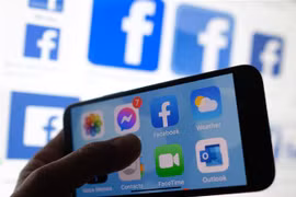 Biểu tượng của mạng xã hội Facebook trên màn hình điện thoại. (Ảnh: AFP/TTXVN)