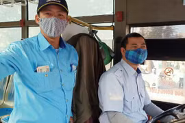 Tài xế và nhân viên bán vé xe buýt của Tổng công ty Vận tải Hà Nội đã đeo khẩu trang trong quá trình phục vụ vận tải hành khách. (Ảnh: CTV/Vietnam+)