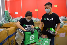 Chỉ trong 6 phút, tài xế hãng xe công nghệ GoViet trở thành Gojek. (Ảnh: PV/Vietnam+)