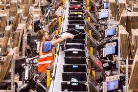 Một công nhân sắp xếp các hộp chứa đơn hàng tại một trung tâm của Amazon tại Italy. (Nguồn: ft.com) 