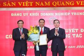 Trưởng Ban Kinh tế Trung ương Nguyễn Văn Bình và Phó Trưởng Ban Thường trực Ban Tổ chức Trung ương Nguyễn Thanh Bình trao quyết định, tặng hoa chúc mừng ông Hoàng Giang giữ chức Phó Bí thư Đảng ủy Khối Doanh nghiệp Trung ương. (Ảnh: Thành Đạt/TTXVN)