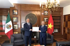Đại sứ đặc mệnh toàn quyền Việt Nam tại Liên bang Mexico Nguyễn Hoài Dương trao quyết định cho ông Miguel Angel Landeros Voquart. (Ảnh: Lưu Việt Hùng/TTXVN)