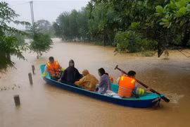 Di chuyển người dân ra khỏi khu vực ngập lũ tại huyện Cam Lộ, tỉnh Quảng Trị. (Ảnh: Thanh Thủy/TTXVN) 