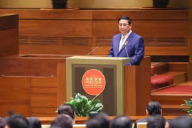 Thủ tướng Phạm Minh Chính trình bày Báo cáo Kết quả Thực hiện Kế hoạch Phát triển Kinh tế-Xã hội năm 2023; Dự kiến Kế hoạch Phát triển Kinh tế-Xã hội năm 2024. (Ảnh: Dương Giang/TTXVN)