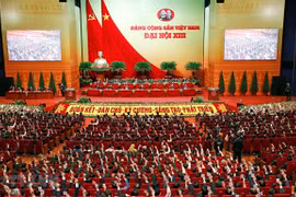 Các đại biểu biểu quyết, thông qua Nghị quyết Đại hội XIII của Đảng. (Ảnh: TTXVN)