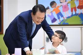 Tổng thống Hàn Quốc Yoon Suk Yeol (trái) thăm Trường Tiểu học Suwon, cách thủ đô Seoul 30km về phía Nam, ngày 3/7/2023. (Ảnh: Yonhap/TTXVN)