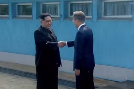 Tổng thống Moon Jae-in và lãnh đạo Kim Jong-un đã bắt tay nhau tại đường ranh giới phân định hai miền. (Nguồn: CNN)