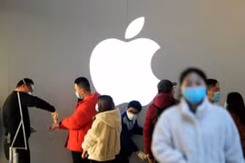 Khách hàng đeo khẩu trang và được kiểm tra thân nhiệt trong một cửa hàng Apple, ở Thượng Hải, Trung Quốc, ngày 21/2. (Nguồn: Reuters)