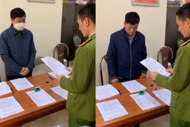 Lực lượng công an tống đạt các quyết định đối với 2 đối tượng Nghiêm Xuân Thông và Lê Văn Diệu. (Ảnh: TTXVN phát)