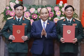 Chủ tịch nước Nguyễn Xuân Phúc, Thống lĩnh các lực lượng vũ trang nhân dân, Chủ tịch Hội đồng Quốc phòng và An ninh, trao Quyết định thăng quân hàm từ Trung tướng lên Thượng tướng đối với các đồng chí Ngô Minh Tiến (bên phải) và Lương Đình Hồng (bên trái)