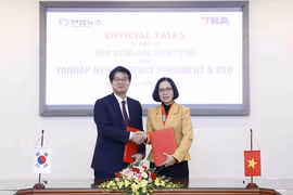 Tổng Giám đốc Thông tấn xã Việt Nam Vũ Việt Trang và Chủ tịch, Giám đốc điều hành Hãng Thông tấn Yonhap Seong Ghi-hong trao Thỏa thuận Hợp tác nghiệp vụ giữa TTXVN và Yonhap. (Ảnh: An Đăng/TTXVN)