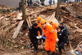 Nhân viên cứu hộ làm nhiệm vụ tại hiện trường vụ lở đất. (Ảnh: Xinhua)