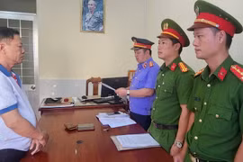 Kiểm sát viên tống đạt Quyết định phê chuẩn lệnh bắt tạm giam đối với Nguyễn Văn Nhưỡng. (Ảnh: TTXVN phát)