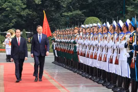Chủ tịch nước Trần Đại Quang và Tổng thống Cộng hoà Ba Lan Andrzej Duda duyệt đội danh dự Quân đội Nhân dân Việt Nam. (Ảnh: Nhan Sáng/TTXVN)