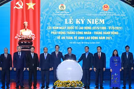 Chủ tịch nước Nguyễn Xuân Phúc và các đại biểu chứng kiến Lễ phát động Tháng công nhân và Tháng hành động về an toàn vệ sinh lao động năm 2021. (Ảnh: Thống Nhất/TTXVN)
