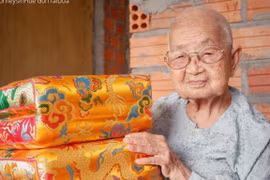 ''Mệ'' Công Tôn Nữ Trí Huệ cầm trên tay sản phẩm trái dựa (gối tựa) cung đình Huế. (Ảnh: Jouneys in Hue)