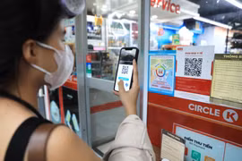 Khách hàng đến siêu thị phải quét mã QR và xịt khử khuẩn trước khi vào mua hàng. 