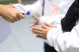 Nhân viên khu vui chơi của 1 trung tâm thương mại kiểm tra nhiệt độ và tẩy trùng vệ sinh để phòng ngừa virus corona. (Ảnh: Thành Đạt/TTXVN)